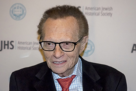 Larry King with a black sports coat and red bow tie. 
