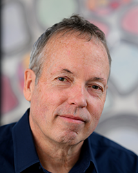 headshot of david ginty wearing a dark blue collared shirt