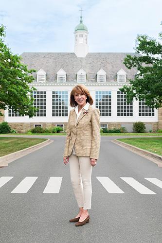 Mila Mulroney standing in the street with a building in the background.