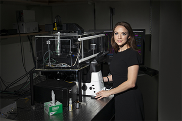 Orefice in her lab wearing a black dress.